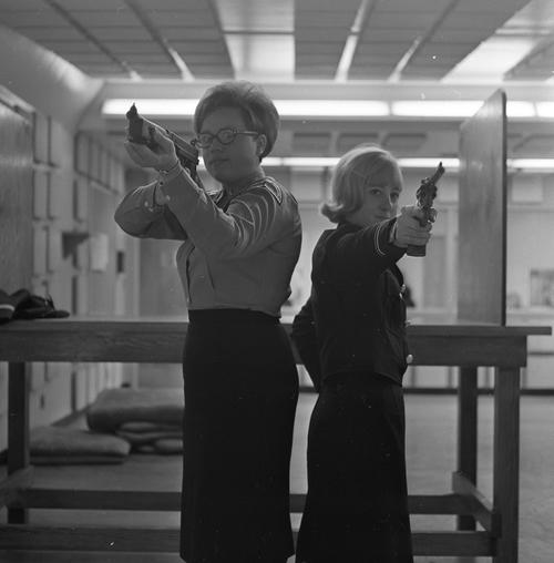 Female cadets posing at shooting range.