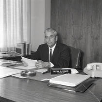Chancellor Glenn S. Dumke sits at his desk.