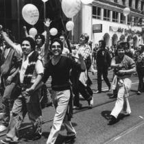 Parade participants carrying balloons.