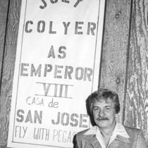 Joey Colyer next to his election banner.
