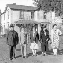 Araki family members standing in front of their house