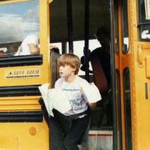 Boy exiting a school bus