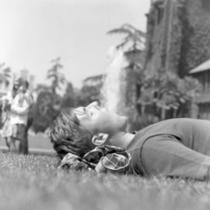Male student sleeping on the lawn